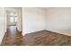 Bright living room with hardwood floors and natural light streaming through doorway, leading to kitchen at 262 Chardon Ave, Brighton, CO 80601