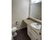 Well-lit half bathroom with a modern sink, vanity, and decorative mirror at 3839 E 135Th Way, Thornton, CO 80241