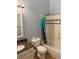 Bright bathroom with a granite countertop, tiled shower and tub combination, and blue walls at 3839 E 135Th Way, Thornton, CO 80241