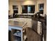 Modern kitchen with stainless steel appliances, dark countertops, and bright white cabinets at 3839 E 135Th Way, Thornton, CO 80241