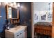 Cozy bathroom featuring stylish rustic mirror and decor, leading into a bedroom with a faux fur throw at 10896 Timothys Dr, Conifer, CO 80433
