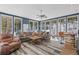 Living room with natural light, wood floors, comfortable seating, and mountain views at 10896 Timothys Dr, Conifer, CO 80433