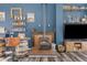 Living room with wood-burning stove, wooden bar, and large windows with a mountain view at 10896 Timothys Dr, Conifer, CO 80433