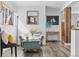 Bright living room with modern flooring, decor, and a view into the next room at 10896 Timothys Dr, Conifer, CO 80433