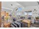 Bright living room boasts large windows, vaulted ceilings, and an inviting sectional sofa at 10896 Timothys Dr, Conifer, CO 80433