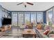 Living room with large windows offering mountain views, wood floors, and comfortable furnishings at 10896 Timothys Dr, Conifer, CO 80433