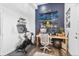 Home office space with exercise bike, desk setup, and wall-mounted snowboards at 10896 Timothys Dr, Conifer, CO 80433