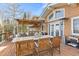 Covered deck with dining set and mountain views at 10896 Timothys Dr, Conifer, CO 80433