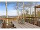 Exterior deck features outdoor dining set with forest views at 10896 Timothys Dr, Conifer, CO 80433