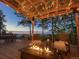 Relaxing outdoor deck area with fire pit, seating, and scenic views at 10896 Timothys Dr, Conifer, CO 80433
