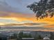 Panoramic sunset view from a property with mountains and clouds at 10896 Timothys Dr, Conifer, CO 80433