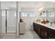 Bathroom featuring a modern glass shower and double vanity at 749 Bishop Pine Way, Castle Rock, CO 80104