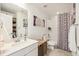 Cozy bathroom featuring a shower with patterned curtain and vanity at 749 Bishop Pine Way, Castle Rock, CO 80104