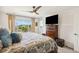 Comfortable bedroom featuring a wooden dresser and a view of the outdoors at 749 Bishop Pine Way, Castle Rock, CO 80104