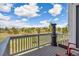 Outdoor deck with chairs and a view of the surrounding trees and blue skies at 749 Bishop Pine Way, Castle Rock, CO 80104