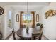 Charming dining area with a round wooden table, four chairs, and a window view at 749 Bishop Pine Way, Castle Rock, CO 80104