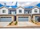 Inviting townhome showcasing a stone facade, blue siding, and attached garages at 749 Bishop Pine Way, Castle Rock, CO 80104