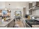 Bright modern kitchen showcasing granite countertops, stainless steel appliances, and a dining area with large windows at 749 Bishop Pine Way, Castle Rock, CO 80104