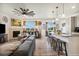 Open living room and kitchen featuring a kitchen island with barstool seating at 749 Bishop Pine Way, Castle Rock, CO 80104