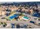 Aerial view of the community featuring pool, tennis court, and mature trees at 430 Zang St # 4-301, Lakewood, CO 80228