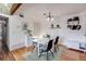 Cozy dining room features wood floors, an elegant light fixture, and seating for four at 430 Zang St # 4-301, Lakewood, CO 80228