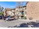 Exterior of building with reserved visitor parking and a manicured lawn at 430 Zang St # 4-301, Lakewood, CO 80228