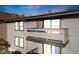 Exterior view of the home shows an outdoor balcony with view of the mountains and city in the distance at 430 Zang St # 4-301, Lakewood, CO 80228