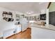 Bright kitchen featuring white cabinetry, wood floors, modern appliances, and a convenient breakfast bar at 430 Zang St # 4-301, Lakewood, CO 80228