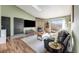 Living room features a stone fireplace, balcony access, and hardwood floors at 430 Zang St # 4-301, Lakewood, CO 80228