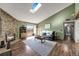 Inviting living room boasts a cozy stone fireplace, vaulted ceiling with skylight, and sliding glass door to balcony at 430 Zang St # 4-301, Lakewood, CO 80228