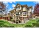 Large backyard featuring a spacious deck, mature landscaping, and beautiful architecture at 9164 E Lost Hill Trl, Lone Tree, CO 80124