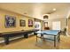 Finished basement featuring a shuffleboard table, ping pong table, and sports memorabilia at 9164 E Lost Hill Trl, Lone Tree, CO 80124