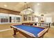 Finished basement featuring a pool table, shuffleboard table, and a ping pong table at 9164 E Lost Hill Trl, Lone Tree, CO 80124
