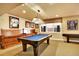 Finished basement featuring a pool table, bench seating, and natural light from the window at 9164 E Lost Hill Trl, Lone Tree, CO 80124