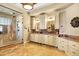 This bathroom features double sink vanities, marble countertops, beautiful tiling and a glass enclosed shower at 9164 E Lost Hill Trl, Lone Tree, CO 80124