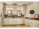 Spacious bathroom boasts double vanities with marble countertops and tile backsplash, complemented by custom cabinets at 9164 E Lost Hill Trl, Lone Tree, CO 80124