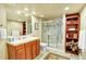 Well-lit bathroom with a glass-enclosed shower, tile floors, and custom vanity at 9164 E Lost Hill Trl, Lone Tree, CO 80124
