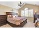 Comfortable bedroom with vaulted ceiling, large window, and elegant dark wood furniture at 9164 E Lost Hill Trl, Lone Tree, CO 80124