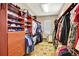 Walk-in closet offers ample storage space with custom shelving, drawers, and hanging rods for organized apparel at 9164 E Lost Hill Trl, Lone Tree, CO 80124