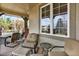 Relaxing covered patio with comfortable seating, outdoor furniture and views of the property at 9164 E Lost Hill Trl, Lone Tree, CO 80124