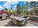 Outdoor deck with dining area, stainless steel grill, and lush green views at 9164 E Lost Hill Trl, Lone Tree, CO 80124