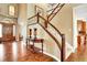 Spacious foyer with hardwood floors, staircase with wood banister, and elegant chandelier at 9164 E Lost Hill Trl, Lone Tree, CO 80124
