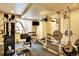 Spacious home gym featuring modern exercise equipment and large windows for plenty of natural light at 9164 E Lost Hill Trl, Lone Tree, CO 80124