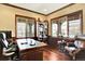 Office with wood floors, built-in shelves, desk, sitting area, and lots of natural light at 9164 E Lost Hill Trl, Lone Tree, CO 80124