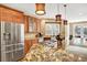 Gourmet kitchen with stainless steel appliances, granite countertops, island gas stove, and farm sink with window at 9164 E Lost Hill Trl, Lone Tree, CO 80124