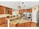 Kitchen island with granite countertop, gas stove, microwave, oven, and breakfast bar with seating at 9164 E Lost Hill Trl, Lone Tree, CO 80124