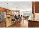 Open concept kitchen with island seating area, dining area, stainless steel fridge, and lots of natural light at 9164 E Lost Hill Trl, Lone Tree, CO 80124