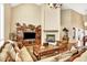 Elegant living room featuring high ceilings, large windows, fireplace and hardwood floors at 9164 E Lost Hill Trl, Lone Tree, CO 80124