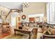 Spacious living room with hardwood floors, staircase with wooden banister, and open floor plan at 9164 E Lost Hill Trl, Lone Tree, CO 80124