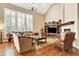 Bright living room features hardwood floors, large windows, and a cozy fireplace at 9164 E Lost Hill Trl, Lone Tree, CO 80124